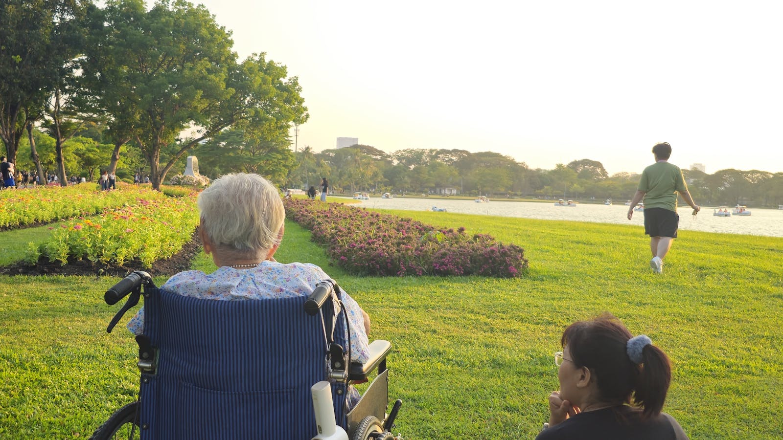 A caregiver and an elderly resident enjoying a Bangkok park